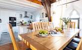 The dining table is next to the kitchen, the perfect sociable layout. - Thumbnail Image