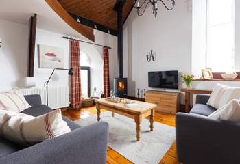 The cosy sofas flank the wood-burner.