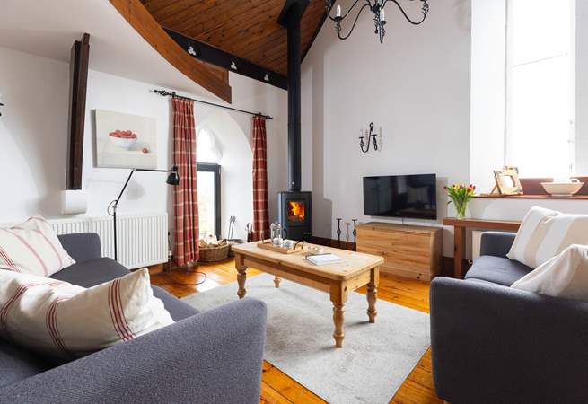 The cosy sofas flank the wood-burner.