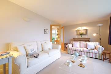 The sitting-room has comfy sofas, inviting you to sit back and relax.