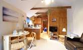 Cosy and welcoming, the open plan living-room with kitchen and dining-area. - Thumbnail Image