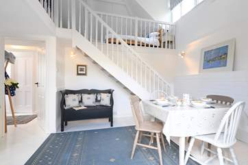 Another view of the dining-area with the hall in the background.