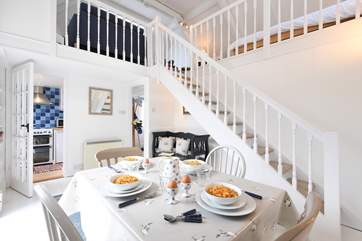 The dining-room with kitchen and hall in the background.