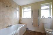 The family bathroom has a bath with shower over.