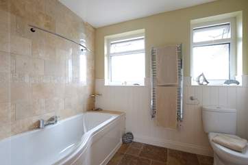 The family bathroom has a bath with shower over.