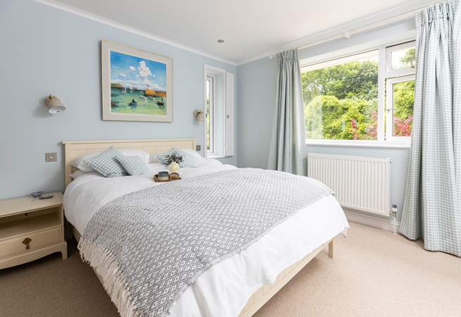 The dreamy master bedroom is decorated in relaxing tones.