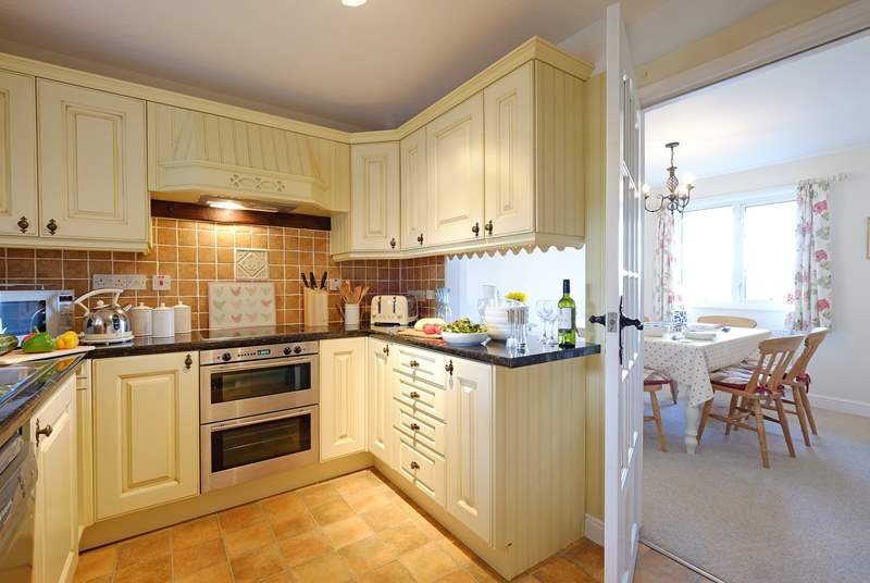 The kitchen is conveniently positioned next to the dining-room.