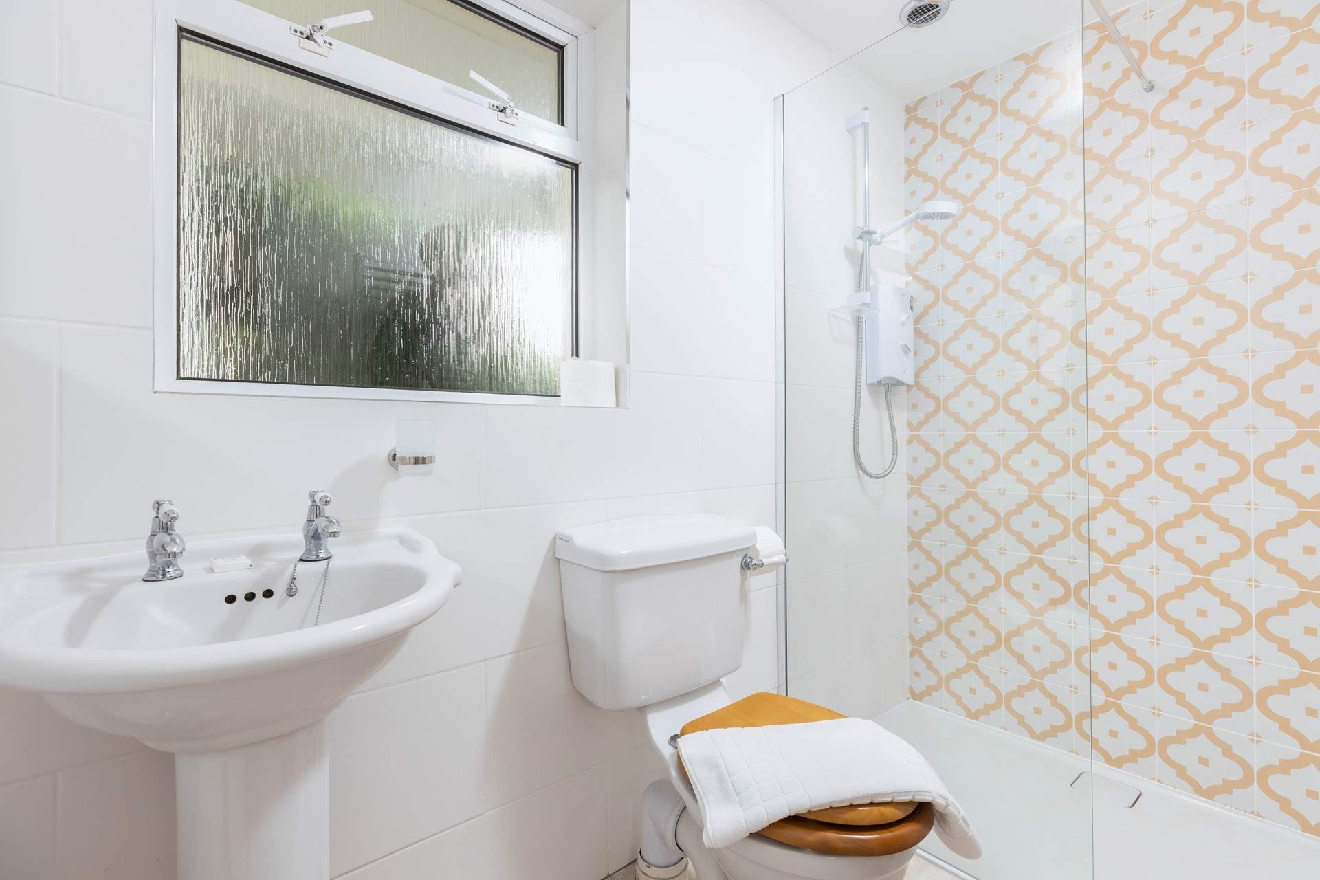 The en-suite shower room to Bedroom 1 on the ground floor.