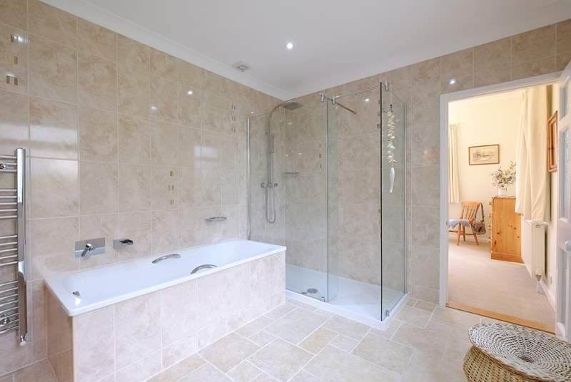 The en suite bathroom for Bedroom 1 has a rainfall shower and bath.