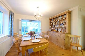 The kitchen has a lovely pine dresser and farmhouse table and chairs.