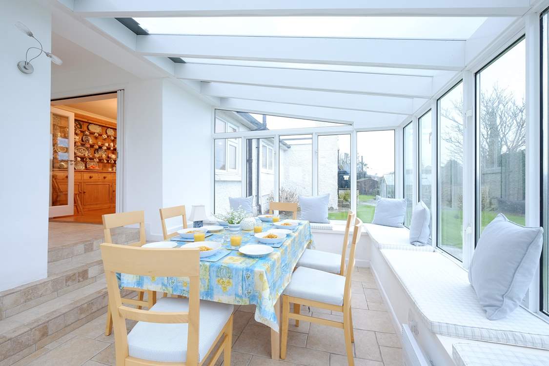 Gather everyone around the conservatory dining table to chat about the day ahead.