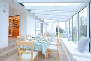 Gather everyone around the conservatory dining table to chat about the day ahead.