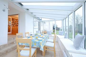Gather everyone around the conservatory dining table to chat about the day ahead.