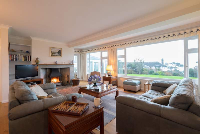 The sitting-room has panoramic views of the lovely garden.