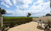 The delightful patio overlooks the surrounding countryside and seascapes. - Thumbnail Image