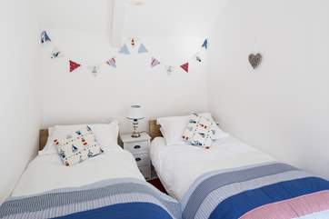 The seaside theme of this twin room will delight children.