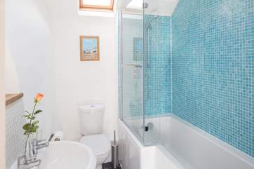 The family bathroom has a 'P' shaped bath and drench shower.