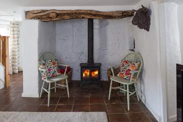 The cosy wood-burner sits within this magnificent fireplace, plus there is a bread oven towards the back.