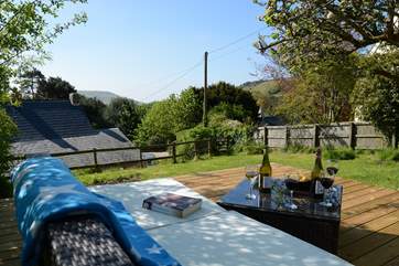The enclosed rear garden sits above and behind the cottage with sea glimpses from the top, take care on the steep access steps.