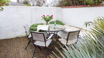 The sheltered courtyard garden faces south-west, making it a tranquil sun-trap.