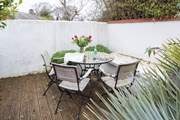 The sheltered courtyard garden faces south-west, making it a tranquil sun-trap.
