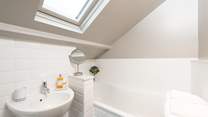 The en suite bathroom has a hand shower attachment and REN products invite you to luxuriate in the bath.
