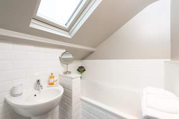The en-suite bathroom has a hand held shower attachment, and REN products invite you to luxuriate in the bath.
