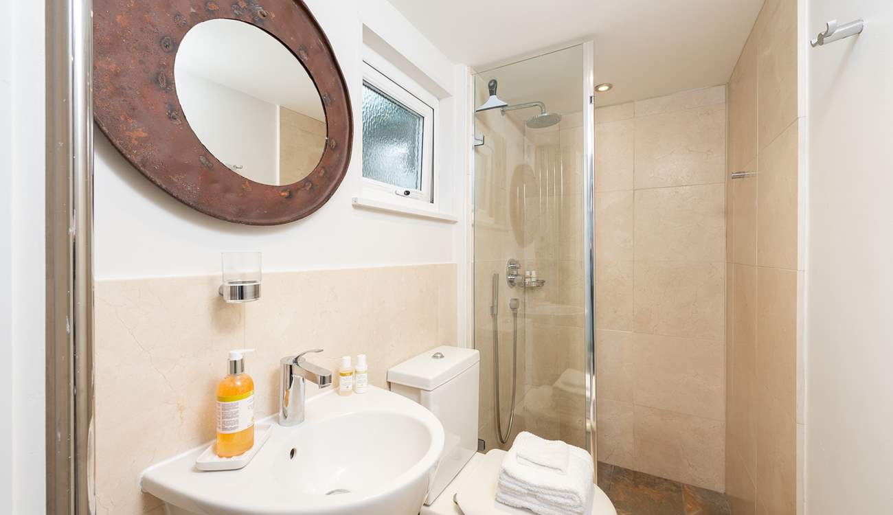 The ground floor shower-room has a large shower with drench head, perfect after a trip to the beach or a day spent sailing.