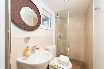 The ground floor shower-room has a large shower with drench head, perfect after a trip to the beach or a day spent sailing.