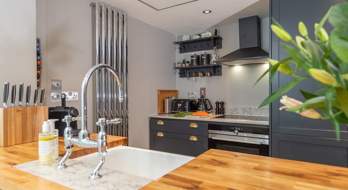 The well-equipped modern kitchen has all you need to conjur up something delicious; beyond is the downstairs shower-room.