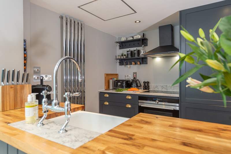 The well-equipped modern kitchen has all you need to conjur up something delicious; beyond is the downstairs shower-room.