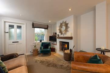The sitting-area has luxurious furnishings and a cosy wood-burner, perfect for relaxing with a good book or a glass of wine.