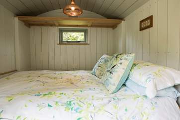 A very comfortable bed that can put pushed back up and out of the way during the daytime to reveal your dining-area. Mattress, linens and all!