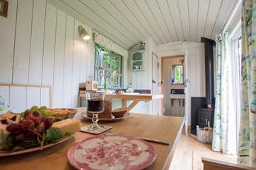 Looking back from the dining-area towards the cosy wood-burner and en suite shower-room.
