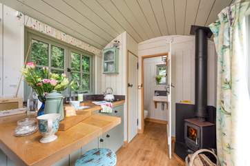 Looking back from the dining-area towards the cosy wood-burner and en suite shower-room.
