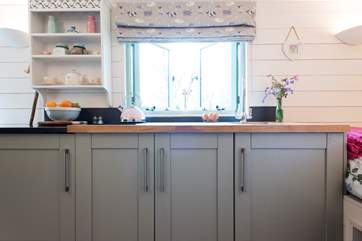 The kitchen-area with two-ring hob and built in fridge.