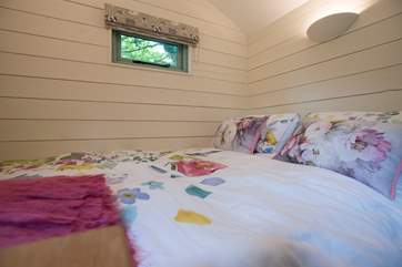 The cosy double bed with comfortable deep mattress awaits.