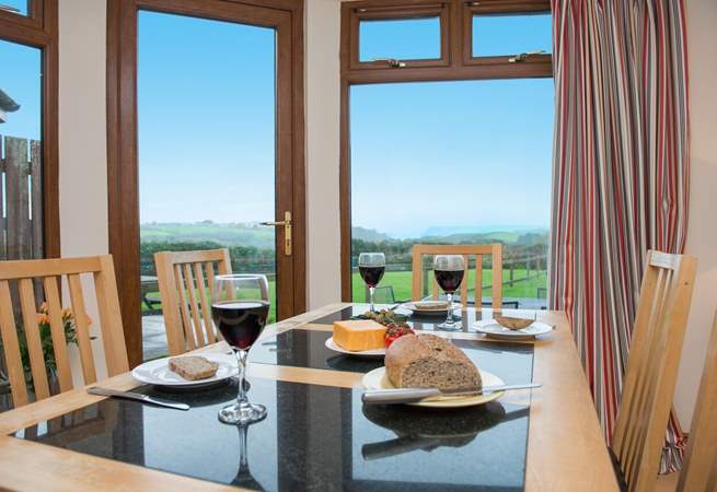 From the dining-area you can look out across the garden and take in the far reaching views of the sea.