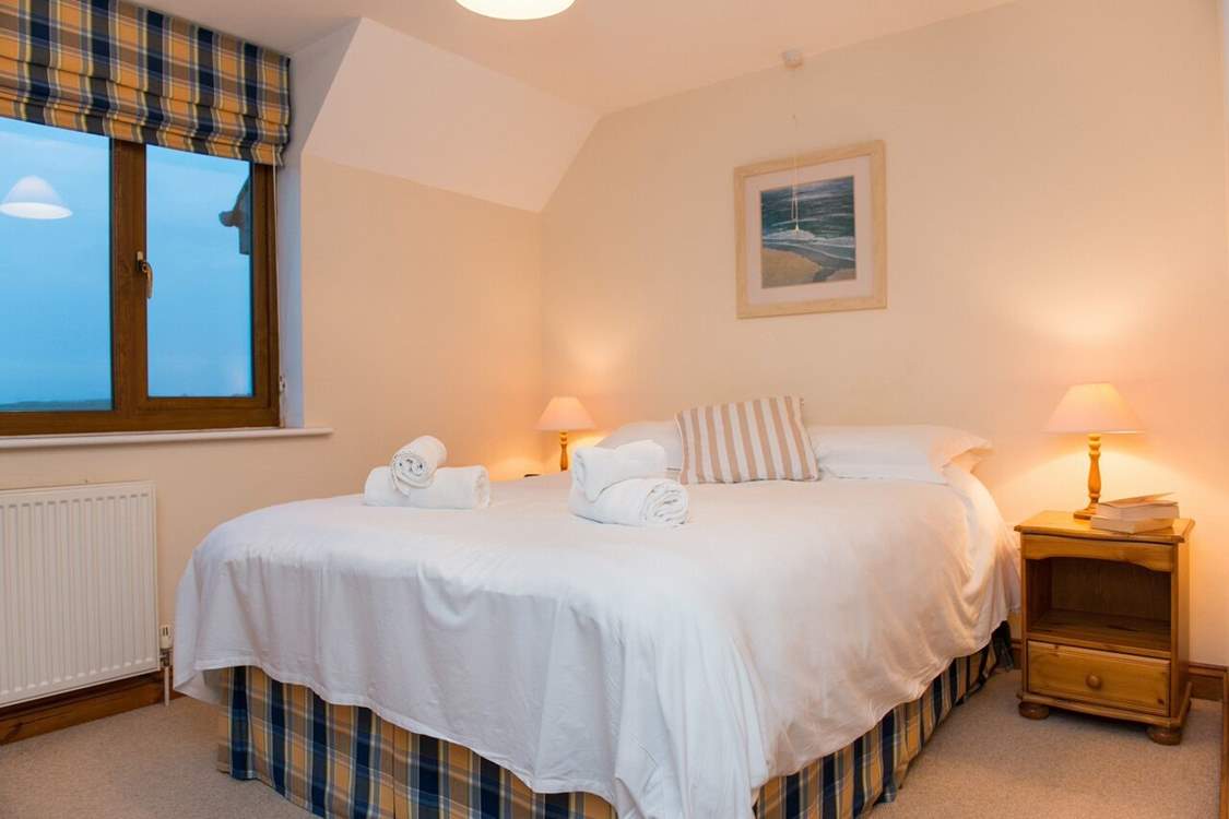 The main bedroom enjoys the views over the golf course and out to sea.