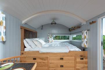 Lovely linens and curtains create a homely feel.