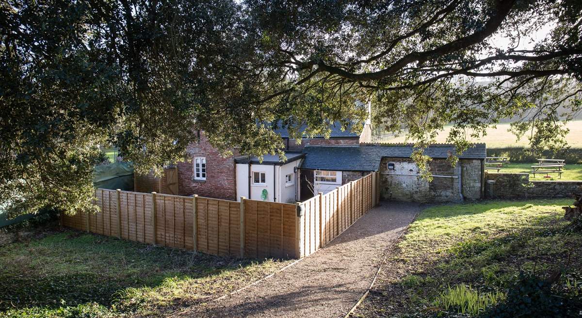 The driveway leading down to the totally enclosed patio at the front of the cottage (you can just see the play area behind).