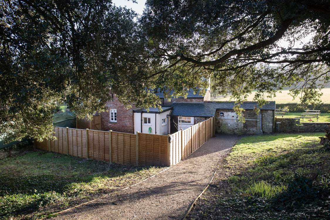 The driveway leading down to the totally enclosed patio at the front of the cottage (you can just see the play area behind).