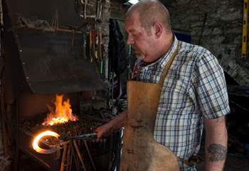 A blacksmith has a forge in the Barrow Centre.