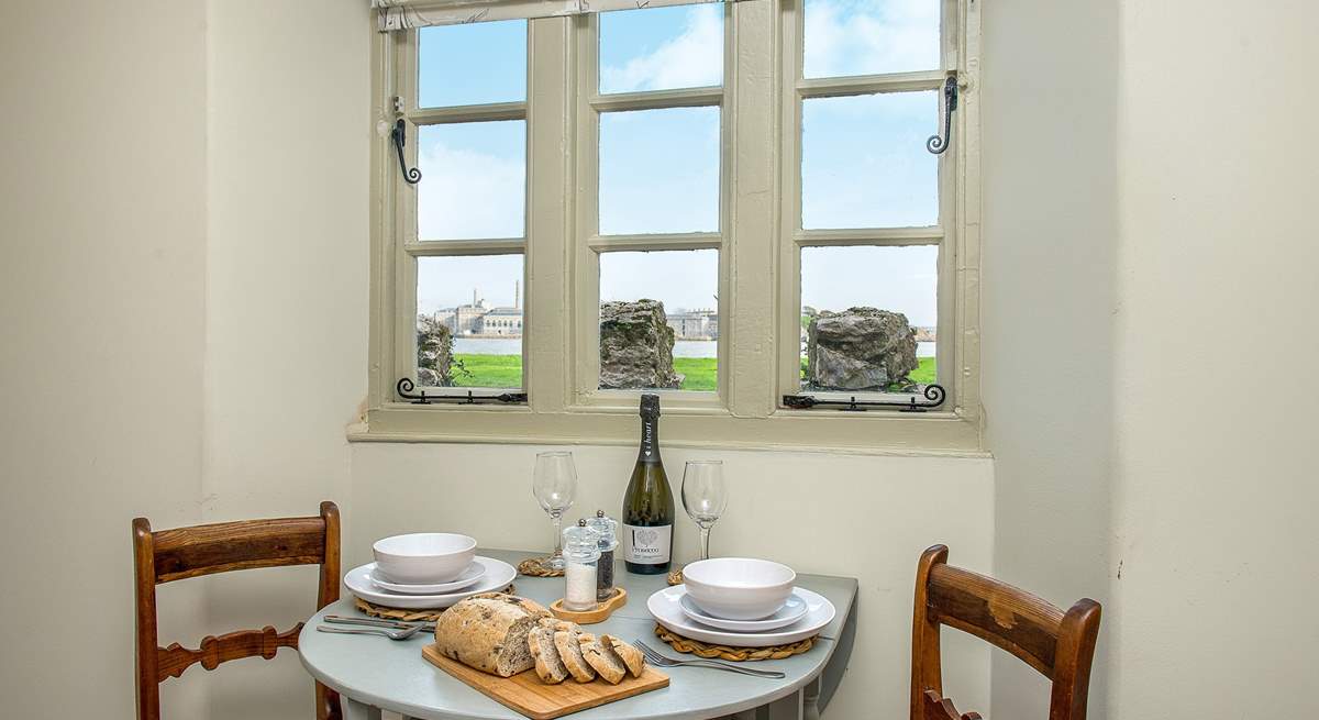 The pretty dining-area enjoys the views across the water.