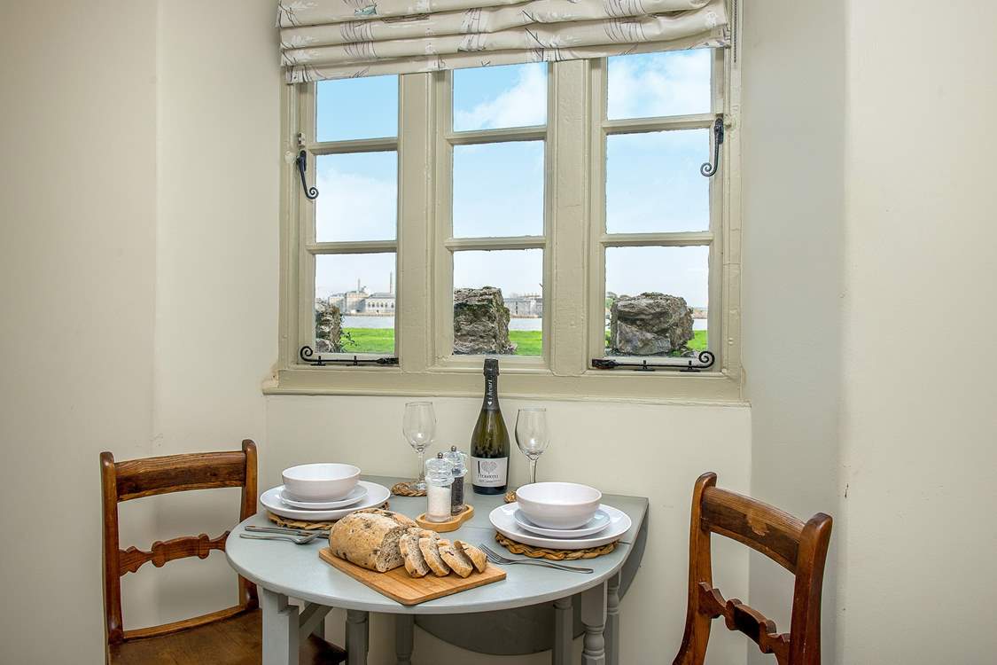 The pretty dining-area enjoys the views across the water.