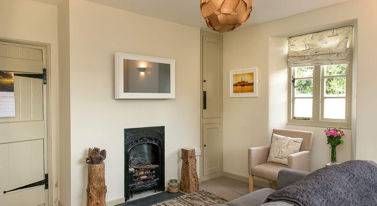 A pretty ornamental fireplace within the sitting-room.