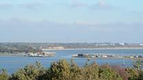 Taken from Hengistbury Head, this view shows the entrance to Christchurch harbour, Mudeford Quay to the left and Mudeford Sandbank to the right.