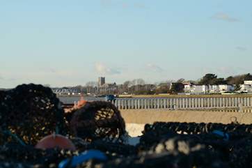 Mudeford Quay, the entrance to Christchurch Harbour, with Christchurch Priory in the distance. A perfect place for children and adults to go crabbing.