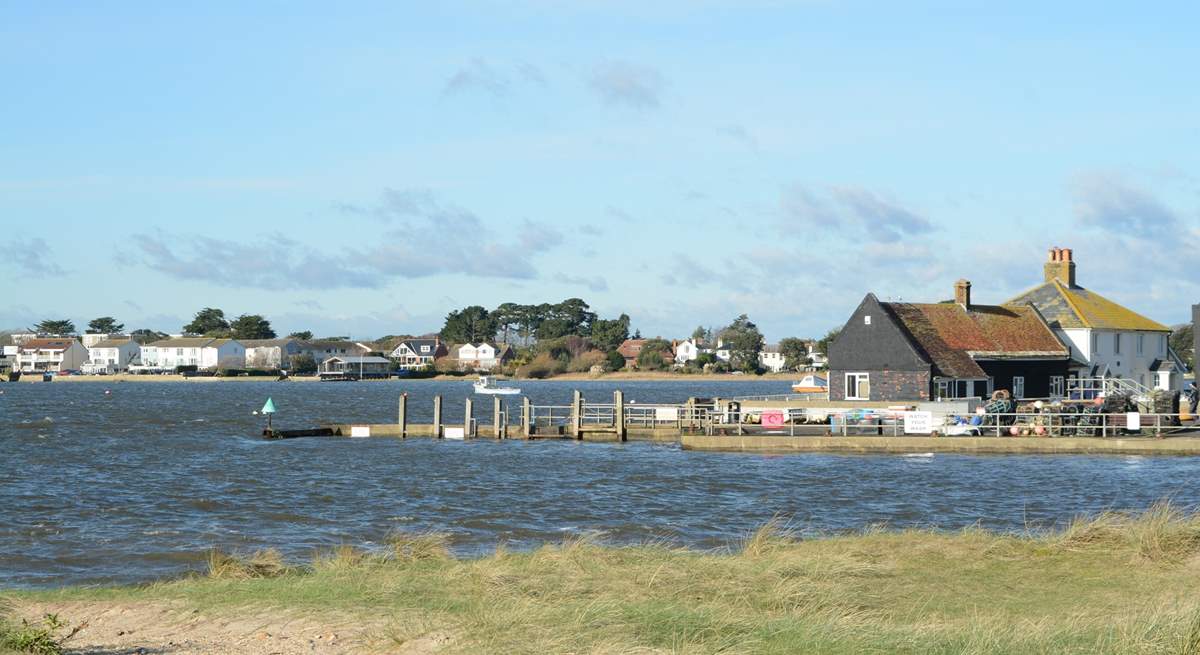 Looking across the mouth of Christchurch Harbour towards Mudeford Quay, ferry trips and adventure boat trips leave from the Quay.