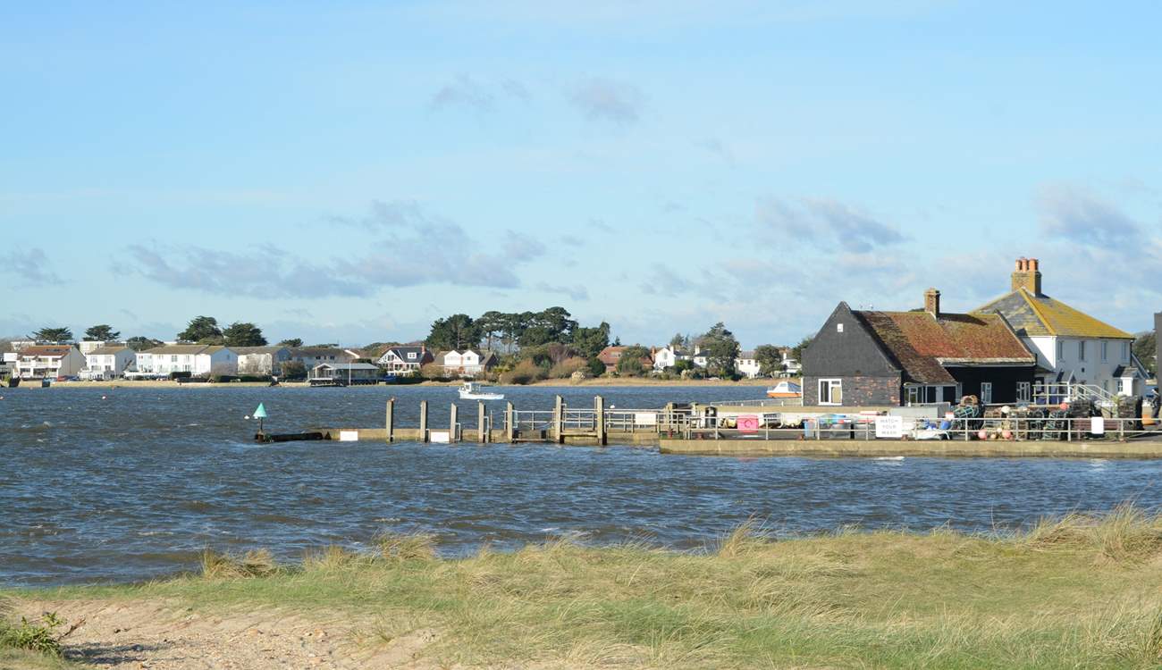 Looking across the mouth of Christchurch Harbour towards Mudeford Quay, ferry trips and adventure boat trips leave from the Quay.
